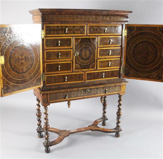 A William and Mary laburnum oyster veneered and crossbanded cabinet on stand, W.3ft 4in. D.1ft 6in. H.4ft 11in.